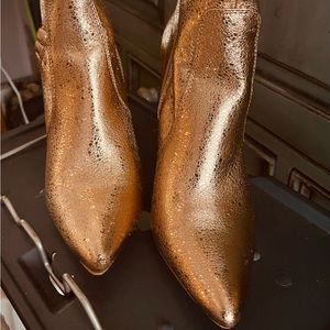 beautiful Rose gold heels with ruffle detail at top of shoe and side zipper.